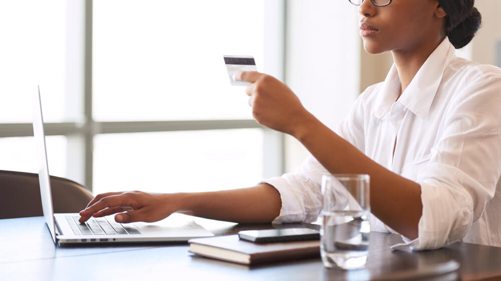 Faceless African American Woman Making Wire Transfers Online Using Her Credit Card